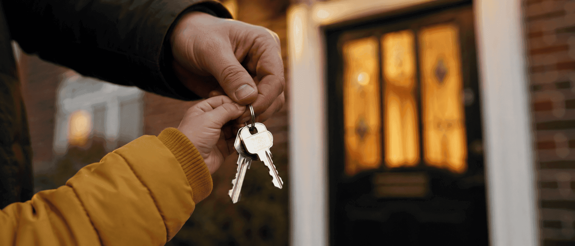 A new set of keys being passed into a waiting hand